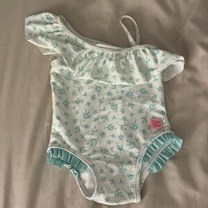 Ruffle Butts Floral One-Shoulder Swimsuit baby girl toddler cream white print